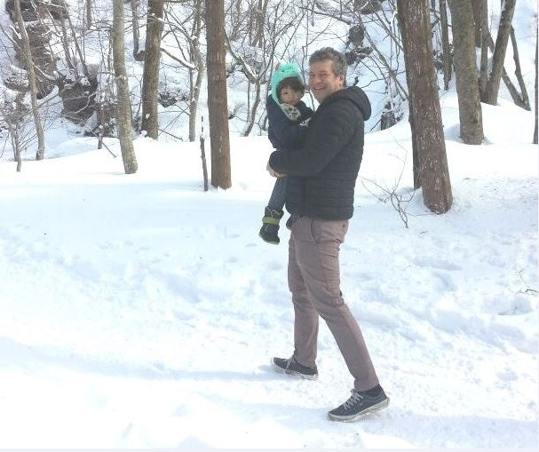 Juan Knaster and child in the snow.