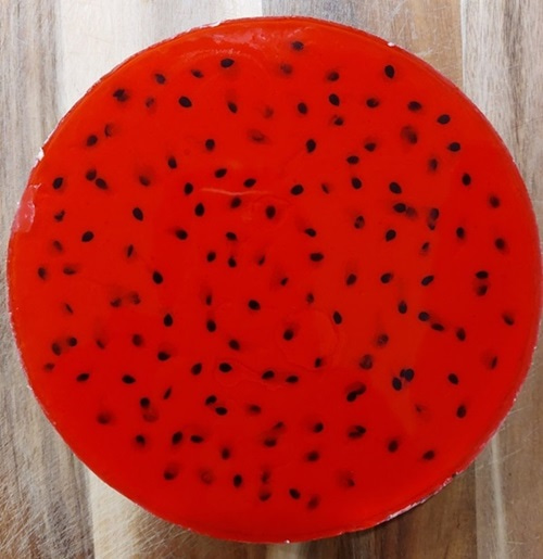 Bright red jelly with black dots.