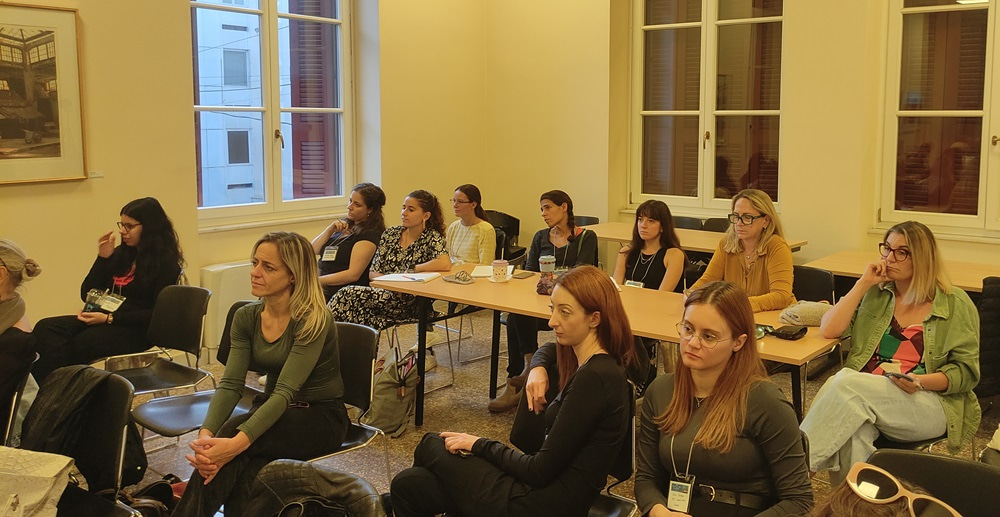 Photo of attendees at the event, listening to the speaker.