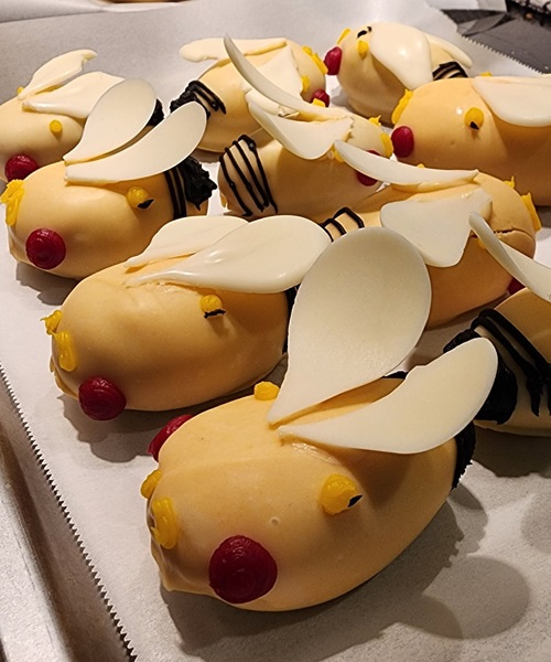 Small cakes decorated with icing to represent flies.