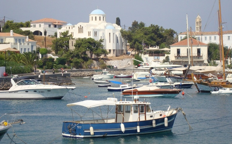 Photo of boats by an old city.