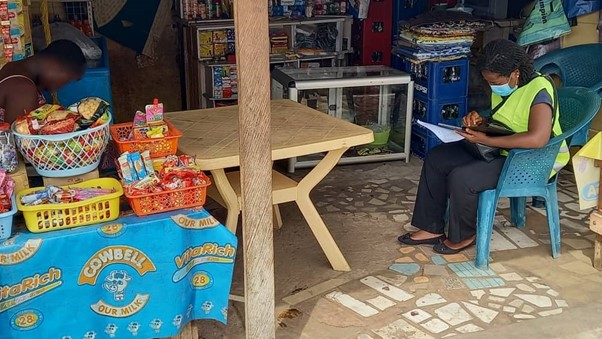Field Officer Administering Survey at a vendor outlet.