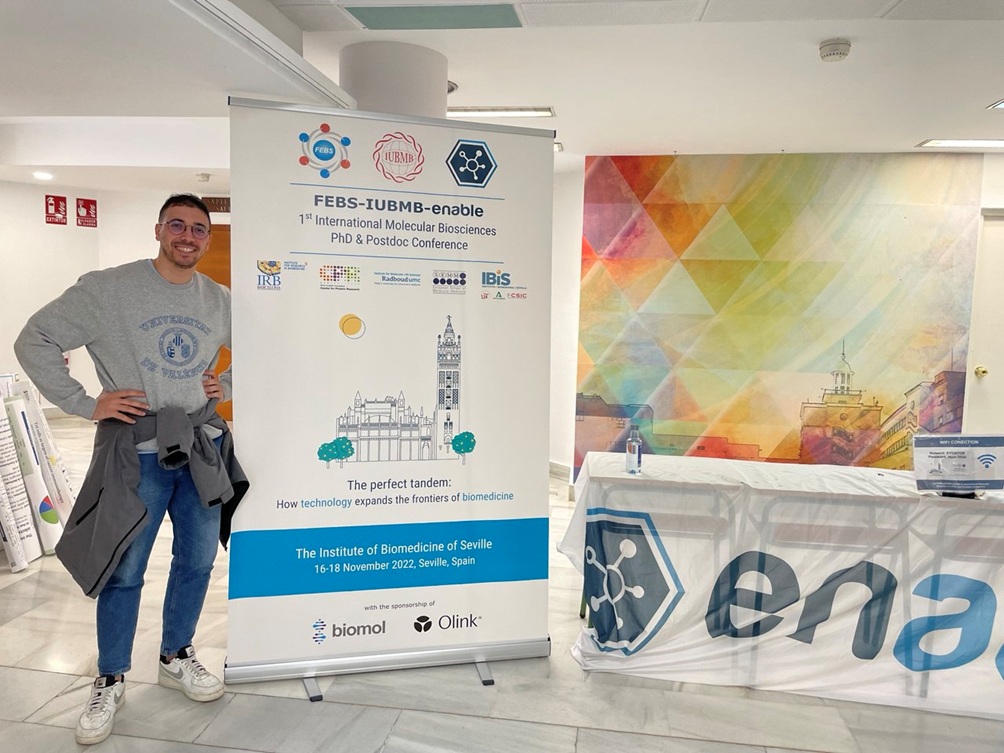 Ignazio Restivo standing by the event pull-up banner.