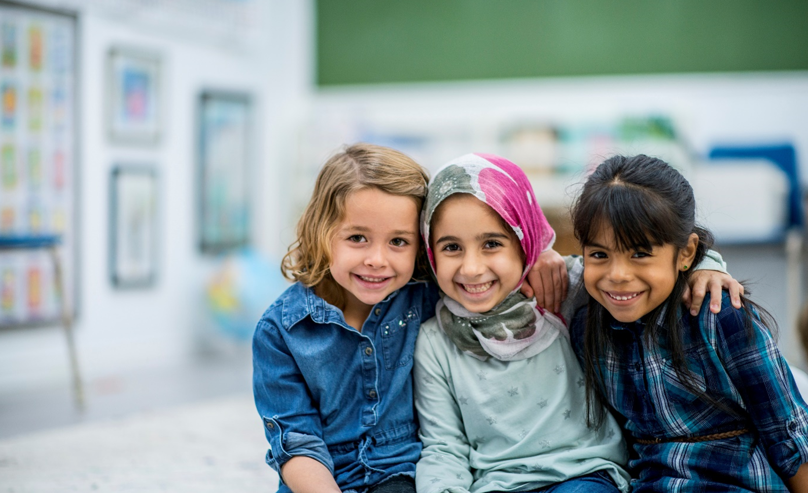 Three smiling young girls.