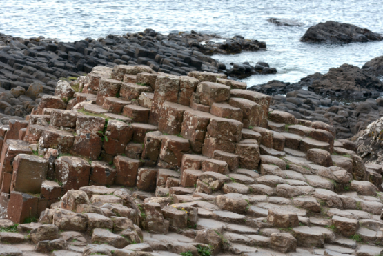 Volcanism and long-term seismicity controlled by plume-induced plate thinning